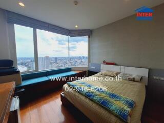 Bedroom with large windows and city view