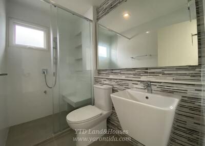 Modern bathroom with shower, toilet, and sink