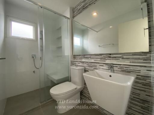 Modern bathroom with shower, toilet, and sink