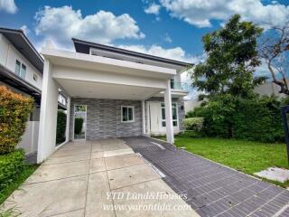 Modern two-story house with driveway and garden