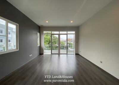 Spacious modern living room with large windows and balcony access