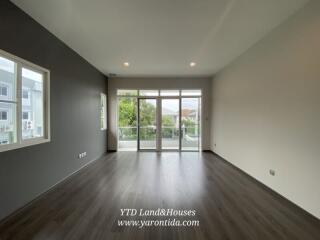 Spacious modern living room with large windows and balcony access