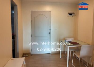 Living area with a door, dining table, chairs, and air conditioning unit