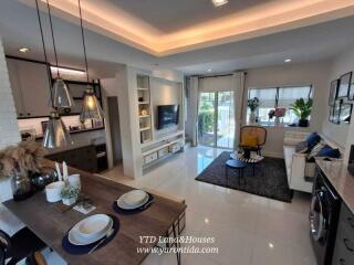 Modern living room with open kitchen and dining area