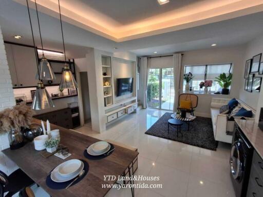 Modern living room with open kitchen and dining area