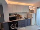 Modern kitchen with white cabinets, gray lower cabinets, and retro refrigerator