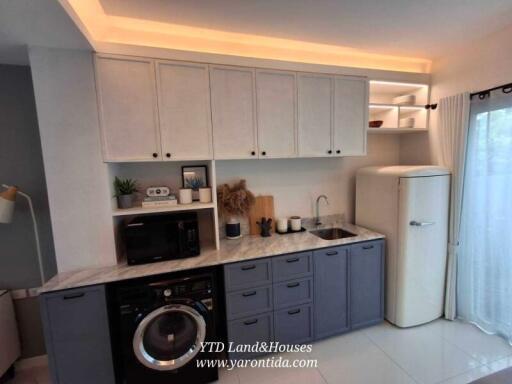 Modern kitchen with white cabinets, gray lower cabinets, and retro refrigerator