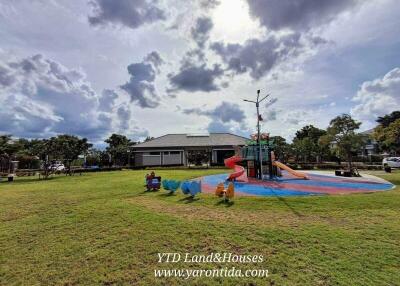 Outdoor playground with slide and green lawn