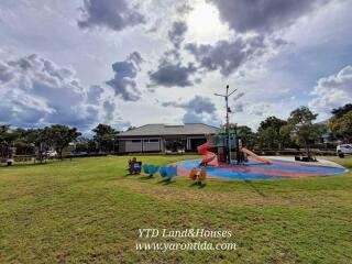 Outdoor playground with slide and green lawn