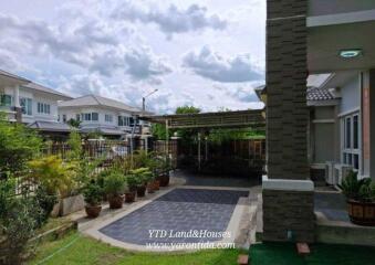 Front yard with driveway and garden