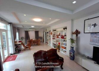 Spacious living room with wooden furniture and decorative shelving