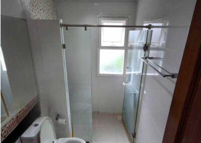 Modern bathroom with glass shower enclosure and toilet