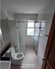 Modern bathroom with glass shower enclosure and toilet