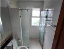 Modern bathroom with glass shower enclosure and toilet