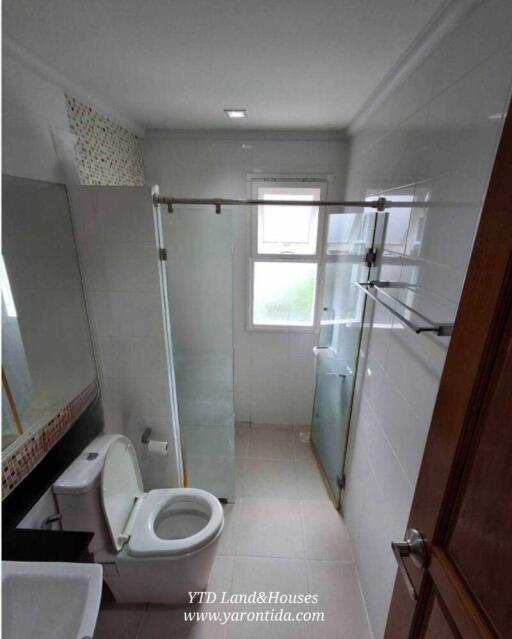 Modern bathroom with glass shower enclosure and toilet