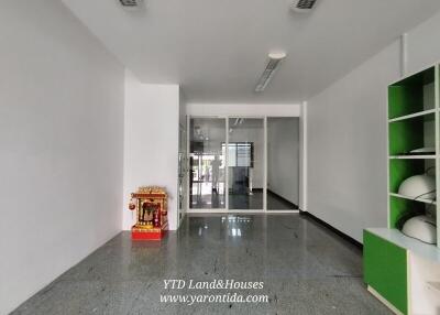 Spacious entryway or lobby area with tiled flooring and white walls.