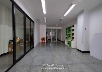 Spacious multi-purpose room with glass partitions and shelving