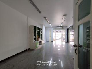 Spacious living area with built-in shelves and large windows