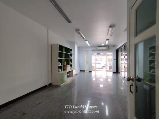 Spacious living area with built-in shelves and large windows