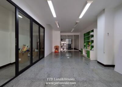 Spacious office with glass partitions and storage shelves