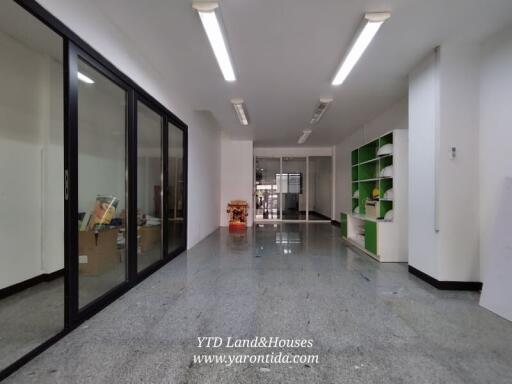 Spacious office with glass partitions and storage shelves