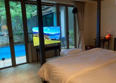 Bedroom with view of pool and patio