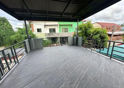 Spacious balcony with tiled flooring and surrounding railing