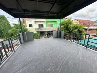 Spacious balcony with tiled flooring and surrounding railing