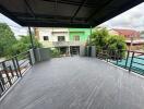 Spacious balcony with tiled flooring and surrounding railing