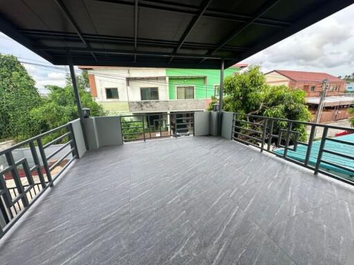 Spacious balcony with tiled flooring and surrounding railing