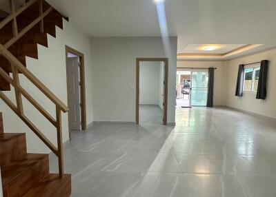 Spacious living room with staircase and large windows