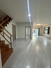 Spacious living room with staircase and large windows