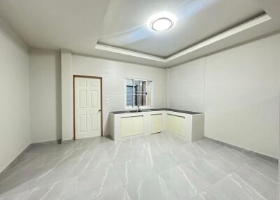 Modern kitchen with white cabinetry and recessed lighting