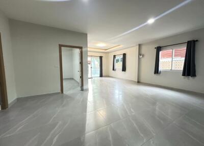 Spacious living room with tiled floors and plenty of natural light