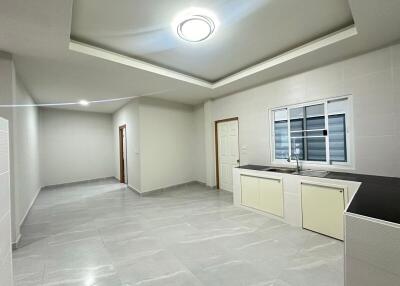 Modern kitchen and living space with tiled floors