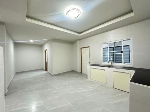 Modern kitchen and living space with tiled floors