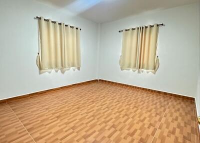 Empty bedroom with tiled floor and curtains