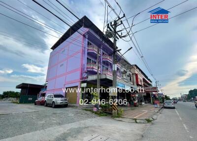 Colorful multi-story building on a busy street corner