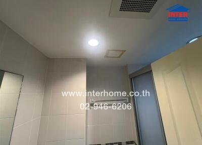 Bathroom ceiling and partial walls with lighting and ventilation