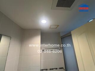 Bathroom ceiling and partial walls with lighting and ventilation