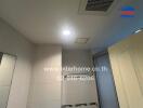 Bathroom ceiling and partial walls with lighting and ventilation