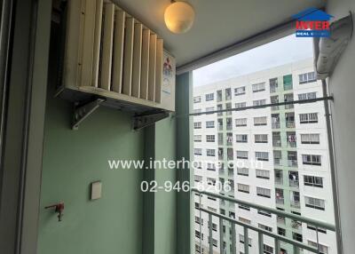 Apartment balcony with a view of neighboring buildings, air conditioning unit installed