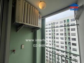 Apartment balcony with a view of neighboring buildings, air conditioning unit installed