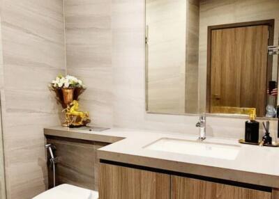 Modern bathroom with wood cabinetry and large mirror