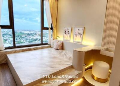 Modern bedroom with large windows and city view