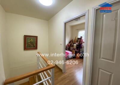 Hallway with wooden flooring and staircase