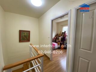 Hallway with wooden flooring and staircase