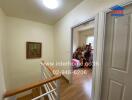 Hallway with wooden flooring and staircase