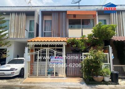 Front view of a residential building with a gated entrance