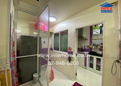 Modern kitchen with glass partition and purple cabinets